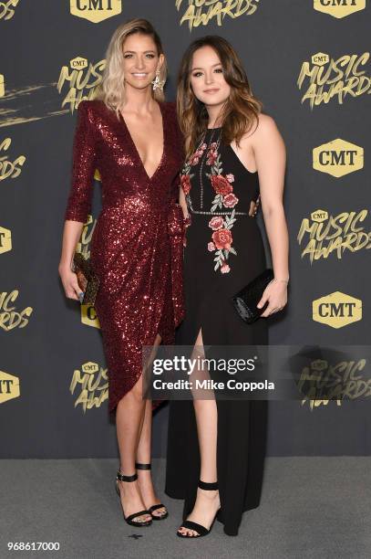 Lindsay James and Hayley Orrantia attend the 2018 CMT Music Awards at Bridgestone Arena on June 6, 2018 in Nashville, Tennessee.