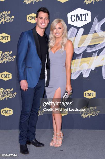 Graham Rahal and Courtney Force attends the 2018 CMT Music Awards at Bridgestone Arena on June 6, 2018 in Nashville, Tennessee.