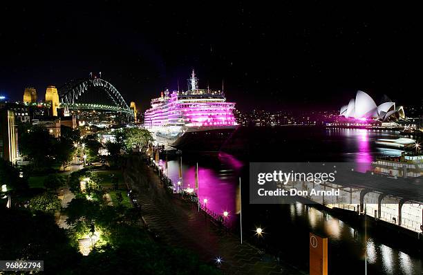 Cunard cruise ship the Queen Victoria is illuminated in pink to raise awareness for breast cancer research in Sydney Harbour on February 19, 2010 in...