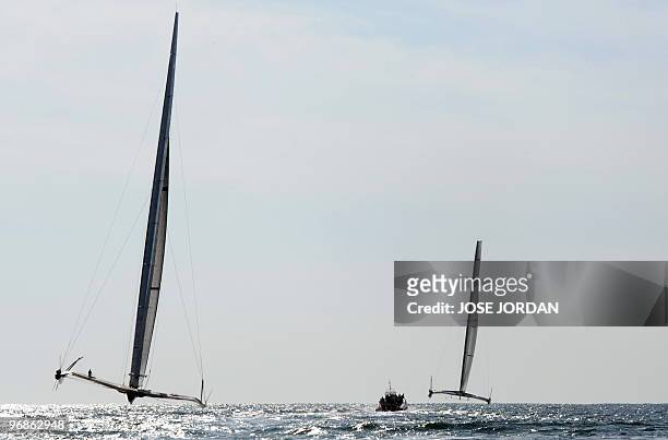 Challenger Oracle giant trimaran and Swiss defender Alinghi huge catamaran sail at the start of the opening race of the 33rd America's Cup off...