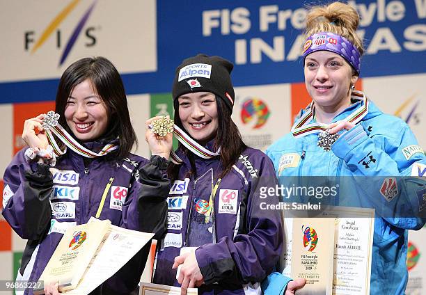 2nd place Miki Ito, winner Aiko Uemura and 3rd place Hannah Kearney of US pose for photographs during the Women's dual moguls medal ceremony during...