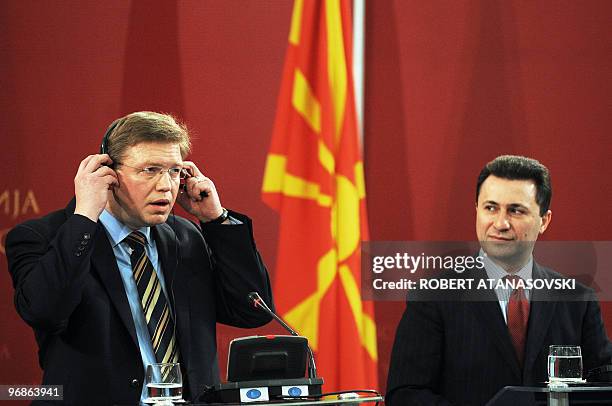 Enlargement Commissioner Czech Stefan Fule adjusts his earphones as Macedonian Prime Minister Nikola Gruevski looks on, at a joint press conference...