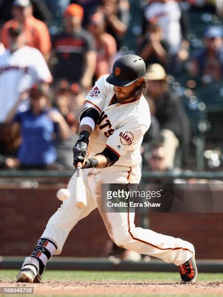 Brandon Crawford of the San Francisco Giants hits a single that scored the winning run in the bottom of the tenth inning against the Arizona...