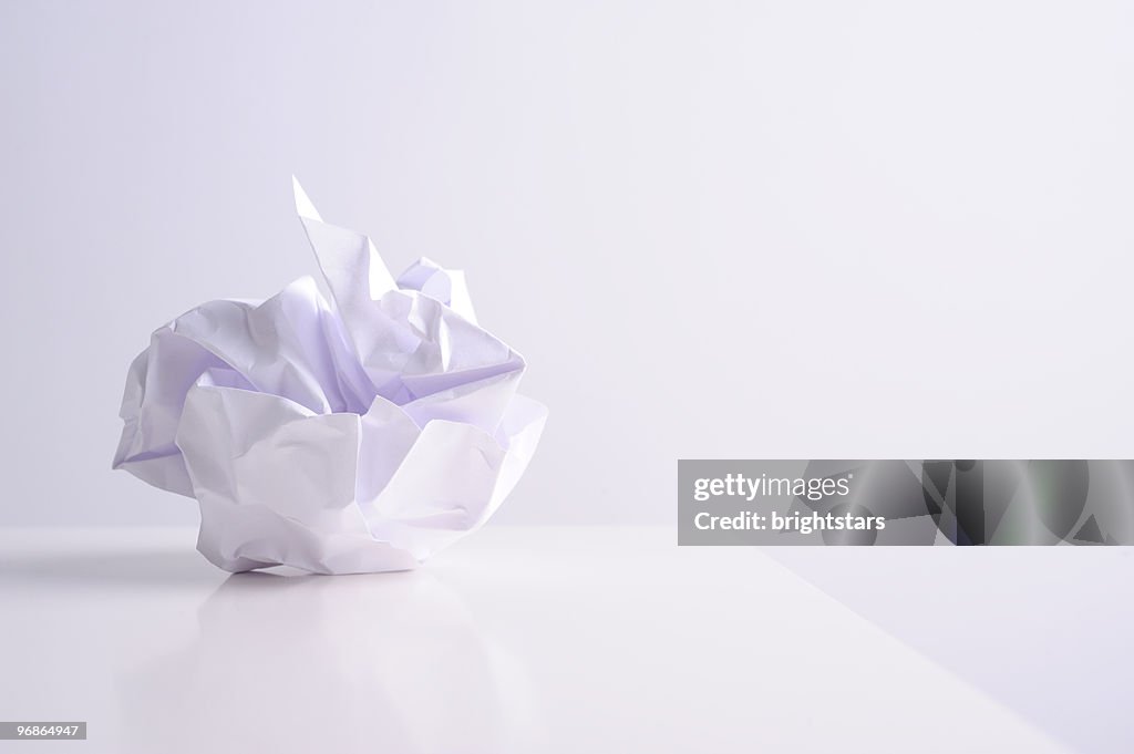 Crumpled paper ball on white