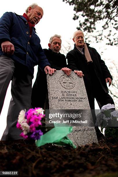 Richard Doyle, Bernard Doyle and Patrick Doyle, nephews of Private Dennis Doyle, pay tribute at his grave on February 19, 2010 in Cambusnethan in...