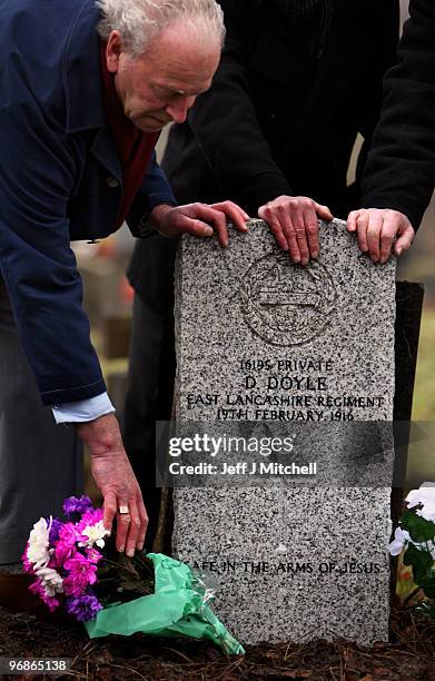 Richard Doyle, Bernard Doyle and Patrick Doyle, nephews of Private Dennis Doyle, pay tribute at his grave on February 19, 2010 in Cambusnethan in...