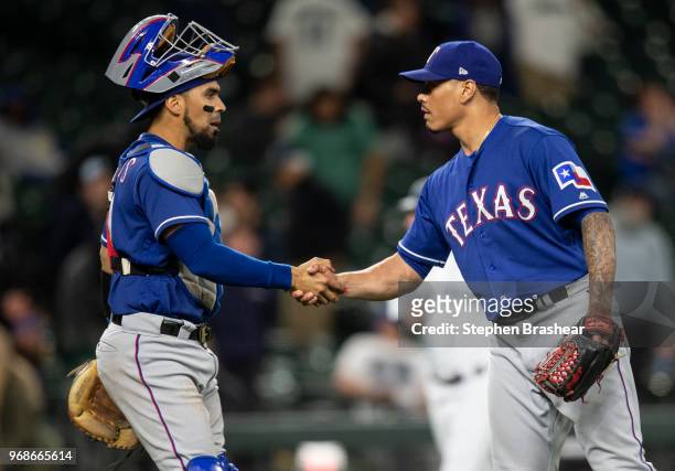 Catcher Robinson Chirinos of the Texas Rangers and relief pitcher Keone Kela of the Texas Rangers celebrate after a game against the Seattle Mariners...