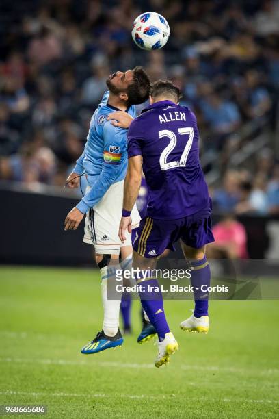 David Villa of New York City wears a rainbow Captain's arm band and goes up for the header against RJ Allen of Orlando City during the MLS the pride...