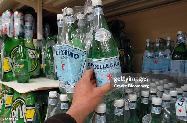 Customer takes a bottle of San Pellegrino water in a supermarket in Paris, France, on Friday, Feb. 19, 2010. Nestle, the bottler of Perrier and...