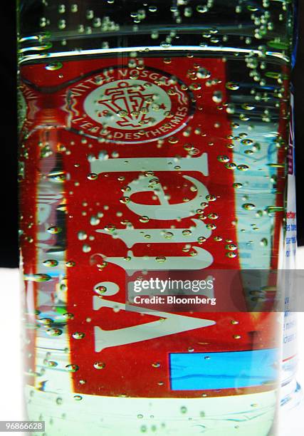 The logo on a bottle of Vittel water, produced by Nestle SA, is seen through water in Paris, France, on Friday, Feb. 19, 2010. Nestle, the bottler of...