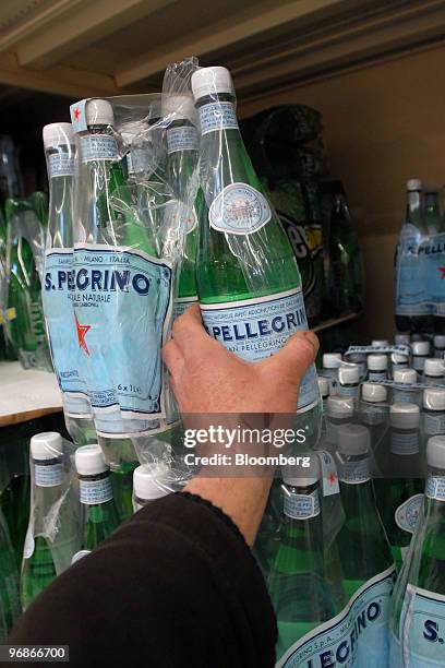 Customer takes a bottle of San Pellegrino water in a supermarket in Paris, France, on Friday, Feb. 19, 2010. Nestle, the bottler of Perrier and...