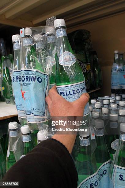 Customer takes a bottle of San Pellegrino water in a supermarket in Paris, France, on Friday, Feb. 19, 2010. Nestle, the bottler of Perrier and...