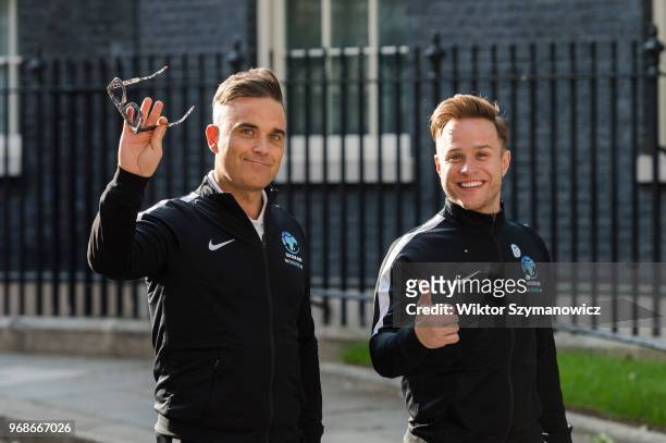 Robbie Williams and Olly Murs leave Downing Street in central London after a reception hosted by Prime Minister Theresa May for teams, ambassadors...