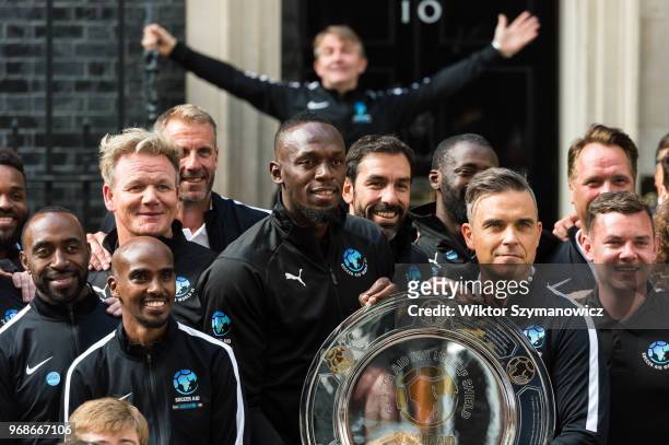 Robbie Williams, holding an official plaque, is joined by Olympic chapions Sir Mo Farah and Usain Bolt together with a host of celebrities,...