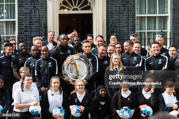 Robbie Williams, holding an official plaque, is joined by Olympic chapions Sir Mo Farah and Usain Bolt together with a host of celebrities,...