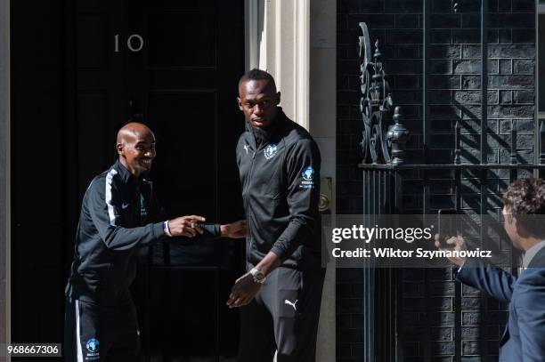 Olympic champions Sir Mo Farah and Usain Bolt pose outside 10 Downing Street in central London before a reception hosted by Prime Minister Theresa...