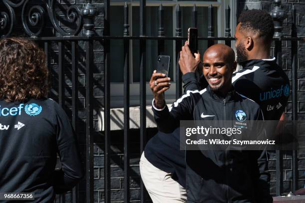 Olympic champion Sir Mo Farah takes a selfie outside 10 Downing Street in central London before a reception hosted by Prime Minister Theresa May for...