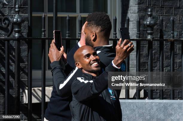 Olympic champion Sir Mo Farah takes a selfie outside 10 Downing Street in central London before a reception hosted by Prime Minister Theresa May for...