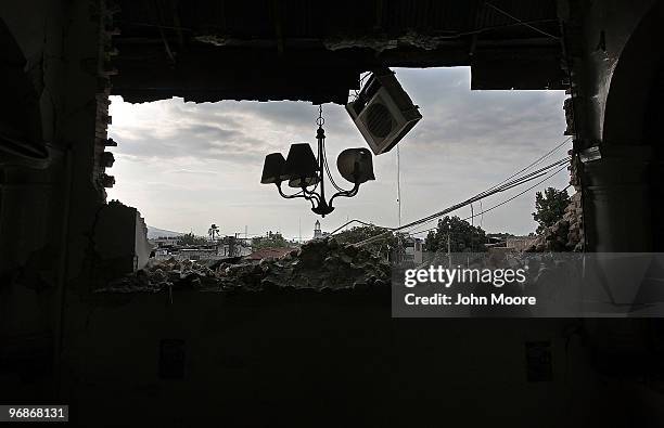 Ceiling lights and an air conditioner hang in the broken edifice of the Ministry of Finance on February 14, 2010 in Port-au-Prince, Haiti. The 7.0...