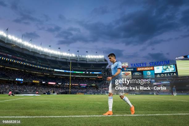 Jesus Medina of New York City heads to the corner to line up for the corner kick with Yankee Stadium in the background during the MLS Pride Night...