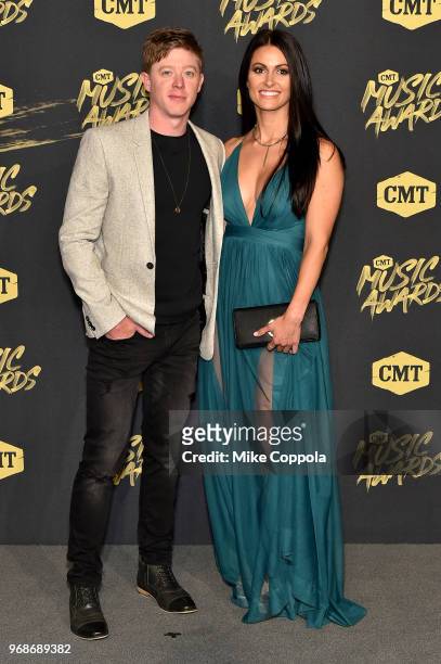 Adam Sanders and guest attend the 2018 CMT Music Awards at Bridgestone Arena on June 6, 2018 in Nashville, Tennessee.