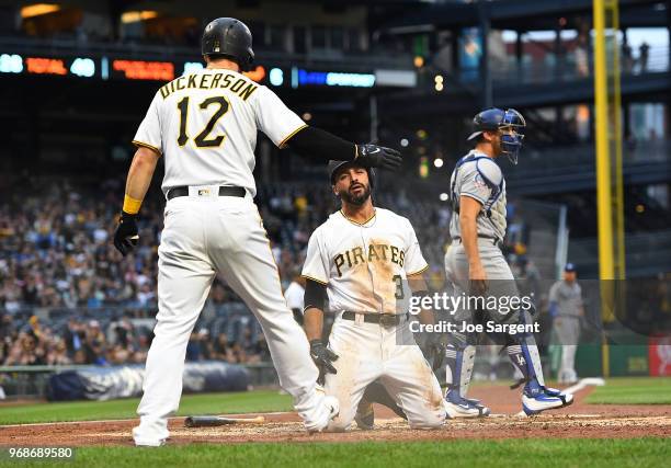 Sean Rodriguez of the Pittsburgh Pirates celebrates with Corey Dickerson after scoring in the second inning against the Los Angeles Dodgers at PNC...