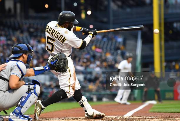 Josh Harrison of the Pittsburgh Pirates hits a three run double during the second inning against the Los Angeles Dodgers at PNC Park on June 6, 2018...