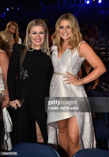 Kelly Clarkson and Lauren Alaina attend the 2018 CMT Music Awards at Bridgestone Arena on June 6, 2018 in Nashville, Tennessee.