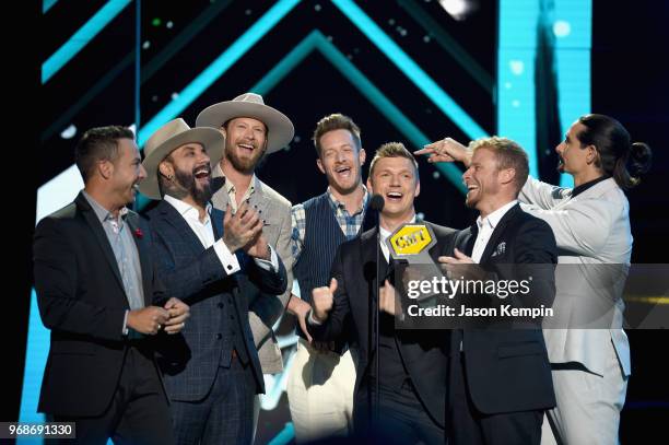 Howie Dorough, AJ McLean, Tyler Hubbard, Brian Kelley, Nick Carter, Brian Littrell and Kevin Richardson accept an award onstage at the 2018 CMT Music...