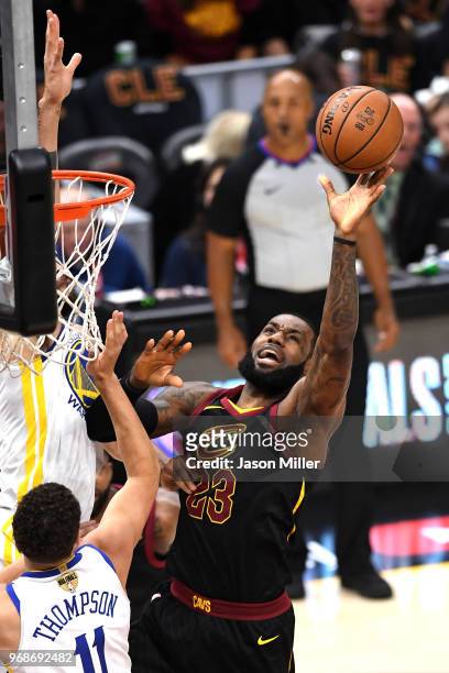 LeBron James of the Cleveland Cavaliers attempts a layup over JaVale McGee of the Golden State Warriors in the first quarter during Game Three of the...