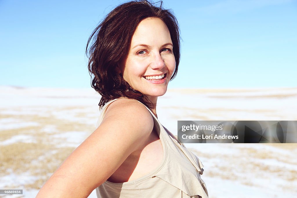 Portrait of woman in snowy field