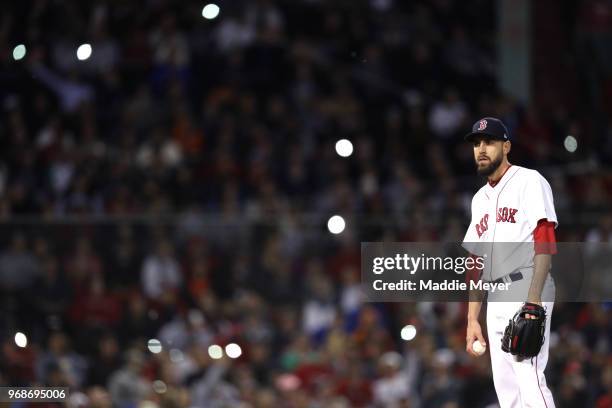 Fans shine the lights on their cell phones in the stands as Matt Barnes of the Boston Red Sox looks on during the seventh inning against the Detroit...