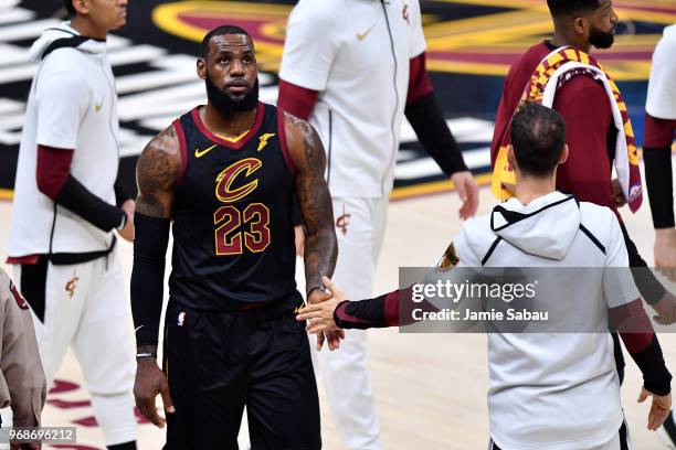 LeBron James of the Cleveland Cavaliers high fives Jose Calderon in the first quarter against the Golden State Warriors during Game Three of the 2018...