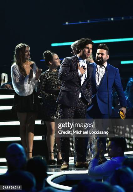 Lennon Stella, Maisy Stella, Kaitlin Doubleday present an award onstage to Dan Smyers and Shay Mooney of Dan + Shay at the 2018 CMT Music Awards at...