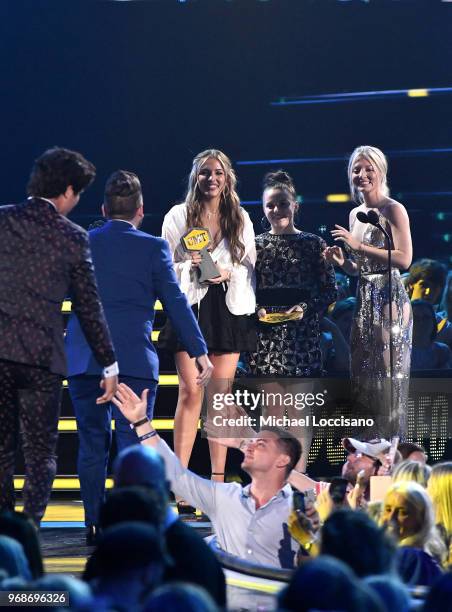 Lennon Stella, Maisy Stella, Kaitlin Doubleday present an award onstage to Dan Smyers and Shay Mooney of Dan + Shay at the 2018 CMT Music Awards at...