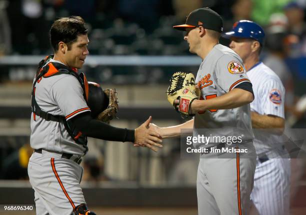 Austin Wynns and Brad Brach of the Baltimore Orioles celebrate after defeating the New York Mets at Citi Field on June 5, 2018 in the Flushing...