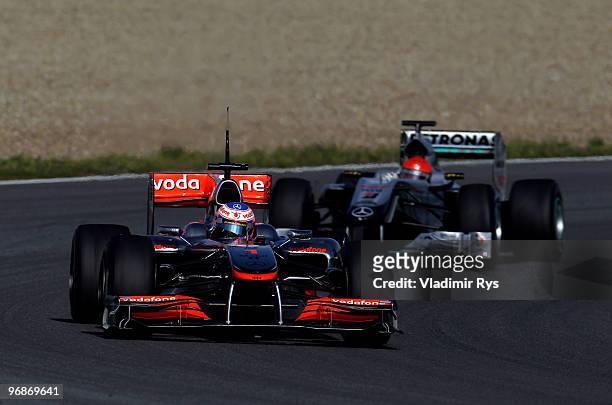 Jenson Button of Great Britain and McLaren Mercedes drives followed by Michael Schumacher of Germany and Mercedes GP during winter testing at the...