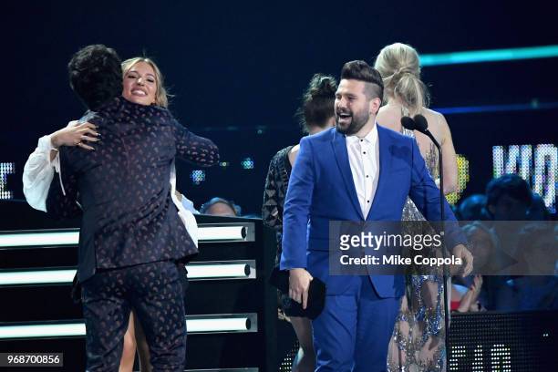 Dan and Shay accept an award from Lennon Stella, Maisy Stella and Kaitlin Doubleday onstage at the 2018 CMT Music Awards at Bridgestone Arena on June...
