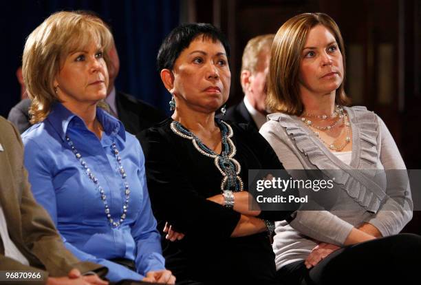 Kathy Battaglia of Tiger Woods Enterprises, Tiger Woods' mother Kultida Woods and Amy Reynolds of Nike listen as golfer Tiger Woods makes a statement...