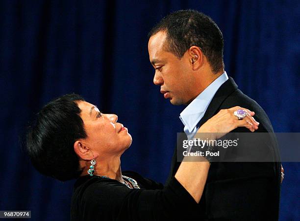 Golfer Tiger Woods hugs his mother Kultida Woods after making a statement from the Sunset Room on the second floor of the TPC Sawgrass, home of the...