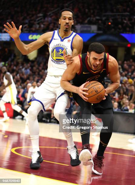 Larry Nance Jr. #22 of the Cleveland Cavaliers drives to the basket defended by Shaun Livingston of the Golden State Warriors in the first half...