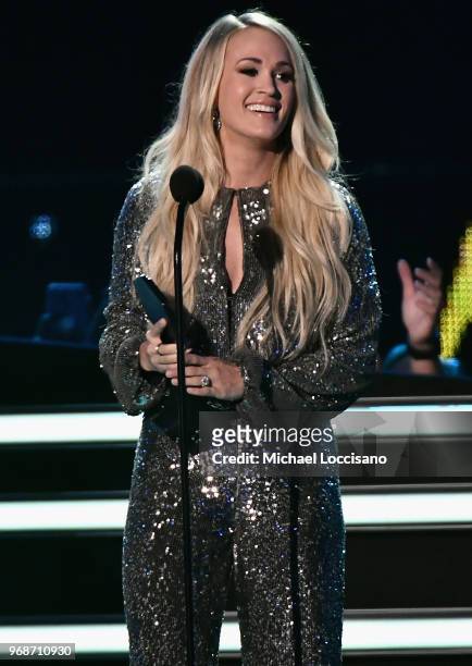 Carrie Underwood accepts an award onstage at the 2018 CMT Music Awards at Bridgestone Arena on June 6, 2018 in Nashville, Tennessee.