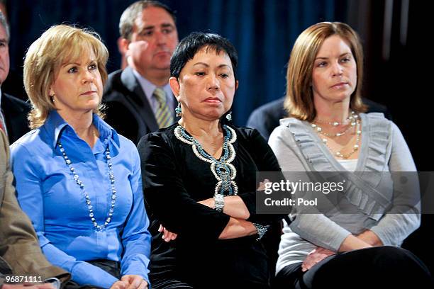 Kathy Battaglia of Tiger Woods Enterprises, Tiger Woods' mother Kultida Woods and Amy Reynolds of Nike listen as golfer Tiger Woods makes a statement...