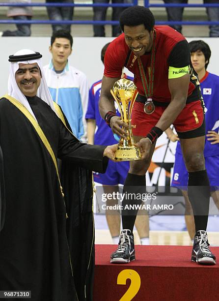 Bahrain's captain Said Jawhar receives the second place trophy from Bahraini Youth and Sports department chief Sheikh Fawaz bin Mohammed al-Khalifa...