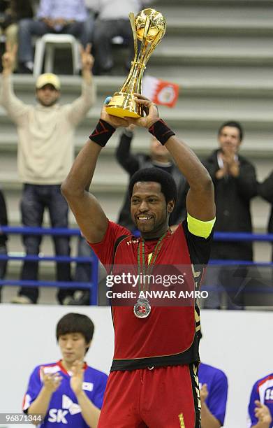 Bahrain's captain Said Jawhar poses with the second place trophy at the end of the Asian handball championship in Beirut on February 19, 2010. South...