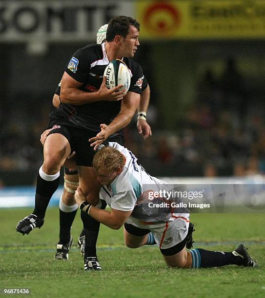 Adriaan Strauss holds on to Bismarck du Plessis during the Super 14 match between The Sharks and Vodacom Cheetahs from Absa Stadium on February 19,...