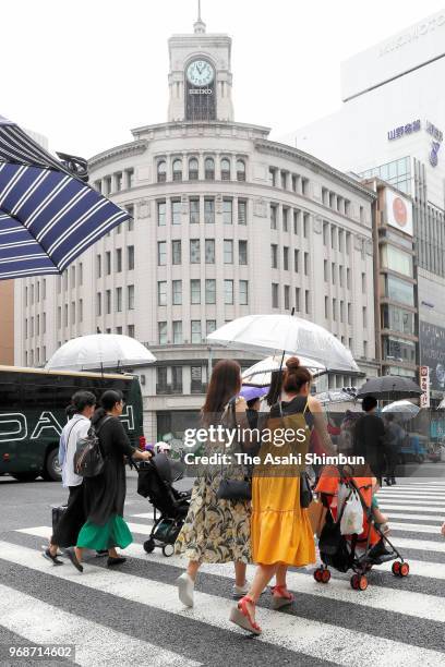 People holding umbrellas walk at Ginza area on June 6, 2018 in Tokyo, Japan. Japan Meteorological Agency said that compared with last year, the rainy...