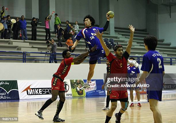 South Korea's Su-Young Jung jumps in the air as he competes with Bahrain's captain Said Jawhar during their Asian handball championship final match...