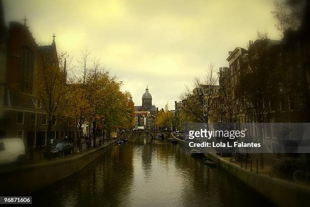 canal in amsterdam  - lola falantes stock pictures, royalty-free photos & images