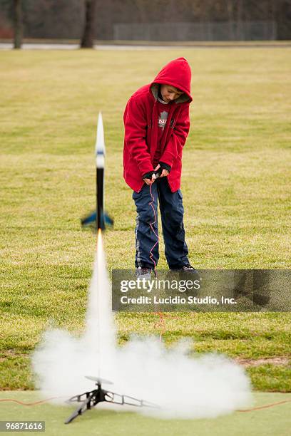 young boy firing a model rocket - model rocket stock pictures, royalty-free photos & images